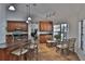 Open kitchen with granite countertops, stainless steel appliances, and breakfast bar with pendant lighting at 12501 Palomino Ct, Tampa, FL 33626