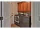 Laundry room with large washer and dryer, tile floor and wood cabinets at 12501 Palomino Ct, Tampa, FL 33626