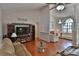 Open-concept living room with hardwood floors, entertainment center, and seamless flow to seating area at 12501 Palomino Ct, Tampa, FL 33626