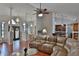 Inviting living room with a large leather sectional, open layout, and elegant chandeliers at 12501 Palomino Ct, Tampa, FL 33626