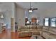 Open-concept living area showcasing a leather sectional sofa and seamless flow to dining and kitchen at 12501 Palomino Ct, Tampa, FL 33626