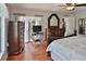 Spacious main bedroom featuring hardwood floors, a ceiling fan, and sliding glass doors leading to an outdoor patio at 12501 Palomino Ct, Tampa, FL 33626