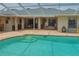 Backyard in-ground pool with a brick patio, steps leading into the pool, and outdoor seating at 12501 Palomino Ct, Tampa, FL 33626
