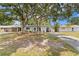 Attractive home with a spacious front yard, showcasing mature trees and a serene neighborhood setting at 133 43Rd Ne Ave, St Petersburg, FL 33703