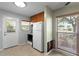 Kitchen showcasing functional appliances and a door, providing both convenience and natural light at 133 43Rd Ne Ave, St Petersburg, FL 33703