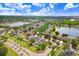 Aerial view of a neighborhood featuring ponds, lush greenery, and well-maintained homes at 13404 Fladgate Mark Dr, Riverview, FL 33579