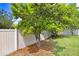 Backyard showcasing mature fruit trees along a white fence at 13404 Fladgate Mark Dr, Riverview, FL 33579