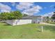 Exterior of house, featuring a privacy fence, well-manicured lawn and solar panels on the roof at 13404 Fladgate Mark Dr, Riverview, FL 33579