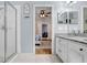 Bright bathroom featuring a glass shower, vanity with granite countertop, and an open doorway to an adjacent room at 13404 Fladgate Mark Dr, Riverview, FL 33579