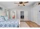 Bright bedroom with ample natural light, a ceiling fan, and wood-look floors at 13404 Fladgate Mark Dr, Riverview, FL 33579