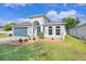 Beautiful home with a two-car garage, manicured lawn, stone details, and arched front entryway at 13404 Fladgate Mark Dr, Riverview, FL 33579