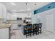 Bright open kitchen with white cabinetry, granite counters, stainless appliances, and breakfast bar at 13404 Fladgate Mark Dr, Riverview, FL 33579