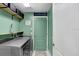Functional laundry room with modern washer and dryer, shelving, and mint-green painted walls at 13404 Fladgate Mark Dr, Riverview, FL 33579