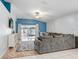 Cozy living room with a comfortable sofa, ceiling fan, and sliding glass doors to the backyard at 13404 Fladgate Mark Dr, Riverview, FL 33579