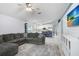 Open-concept area connects the kitchen to the living room featuring a large gray sofa at 13404 Fladgate Mark Dr, Riverview, FL 33579