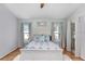 Cozy main bedroom with a wooden framed bed, bright lighting, and light colored walls at 13404 Fladgate Mark Dr, Riverview, FL 33579