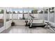 Bright sun room featuring workout equipment with views of the privacy fenced yard and outdoor patio at 13404 Fladgate Mark Dr, Riverview, FL 33579