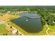 An aerial view showcasing the park's lake and walking bridge at 13916 Wellesford Way, Tampa, FL 33624
