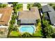 Aerial view of a single Gathering home with a large backyard, swimming pool, and covered patio at 13916 Wellesford Way, Tampa, FL 33624