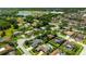 Aerial view of residential neighborhood highlighting home with pool in lush green environment at 13916 Wellesford Way, Tampa, FL 33624