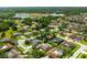 Aerial view of a residential neighborhood showcasing a home with an in-ground pool and backyard at 13916 Wellesford Way, Tampa, FL 33624