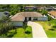 Aerial view of home with a manicured lawn and a brick paver driveway at 13916 Wellesford Way, Tampa, FL 33624