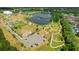 Aerial view of the community park with walking trails, water features, and a parking area at 13916 Wellesford Way, Tampa, FL 33624