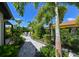 Inviting backyard with a fire pit and stone pathway, lined with lush plants at 13916 Wellesford Way, Tampa, FL 33624