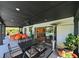 Spacious covered patio featuring a dining area, seating area and a view of the pool at 13916 Wellesford Way, Tampa, FL 33624