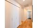 Bright hallway with hardwood floors and large closet offers ample storage space at 13916 Wellesford Way, Tampa, FL 33624