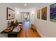 Hallway with hardwood floors, sconces, and decorative console table at 13916 Wellesford Way, Tampa, FL 33624