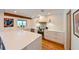 Bright kitchen features white cabinets, quartz countertops, stainless appliances, and a large center island at 13916 Wellesford Way, Tampa, FL 33624