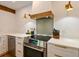 Close-up of kitchen stove, range hood, and backsplash at 13916 Wellesford Way, Tampa, FL 33624