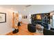 Open living room with built-in shelving, fireplace, and modern accent chairs at 13916 Wellesford Way, Tampa, FL 33624
