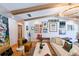 Living room with vaulted ceilings with wood beams, artwork on the wall, and comfortable seating at 13916 Wellesford Way, Tampa, FL 33624