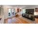 Bright main bedroom with hardwood floors, patio access, and closet at 13916 Wellesford Way, Tampa, FL 33624