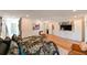 Bright main bedroom features hardwood floors, a closet, and TV at 13916 Wellesford Way, Tampa, FL 33624