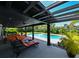 Inviting outdoor living space with pool views, featuring stylish lounge chairs and tropical landscaping at 13916 Wellesford Way, Tampa, FL 33624