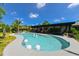 Beautiful backyard pool surrounded by lush landscaping, an outdoor living space and patio at 13916 Wellesford Way, Tampa, FL 33624