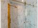 Close up of shower with marble, glass door, and gold fixtures including mounted shower head at 13916 Wellesford Way, Tampa, FL 33624