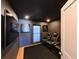 Home theater room with reclining leather seating, dark walls, and large television screen for movie viewing at 13916 Wellesford Way, Tampa, FL 33624