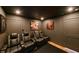 Home theater room features reclining leather seats, black walls, and ceiling with recessed lighting at 13916 Wellesford Way, Tampa, FL 33624