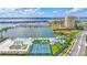 Amazing aerial view of the community's amenities including the marina, pool, tennis courts, and clubhouse, all with water views at 140 Riviera Dunes Way # 1203, Palmetto, FL 34221