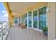 Expansive balcony with seating areas and panoramic water views at 140 Riviera Dunes Way # 1203, Palmetto, FL 34221