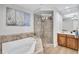 Beautiful bathroom with a soaking tub, glass-enclosed shower, and modern fixtures at 140 Riviera Dunes Way # 1203, Palmetto, FL 34221