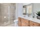Modern bathroom featuring a tiled shower with glass door and single sink vanity at 140 Riviera Dunes Way # 1203, Palmetto, FL 34221