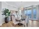 Elegant dining room with modern chandelier, table and chairs, and a beautiful water view at 140 Riviera Dunes Way # 1203, Palmetto, FL 34221