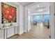 Lovely condo foyer with wood floors, stylish furniture and artwork and views into the dining area and out to the water beyond at 140 Riviera Dunes Way # 1203, Palmetto, FL 34221