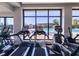 Community gym with treadmills overlooking the outdoor pool through a large window at 140 Riviera Dunes Way # 1203, Palmetto, FL 34221