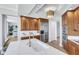 Chef's kitchen features stainless steel appliances, custom cabinetry, and a center island with breakfast bar at 140 Riviera Dunes Way # 1203, Palmetto, FL 34221